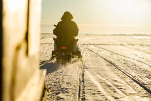 Snowmobile pulling a qamutik on the frozen ocean in Nunavut.