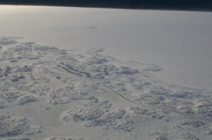 Aerial view of snowy and sunny Whale Cove in Nunavut