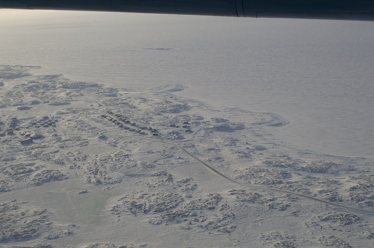 Aerial view of snowy and sunny Whale Cove in Nunavut