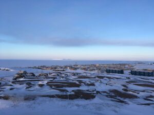 Community of Kugluktuk in Nunavut. Photograph taken in winter with the sun shining over the community.