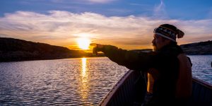 Person in Canoe at sunset in Nunavut.